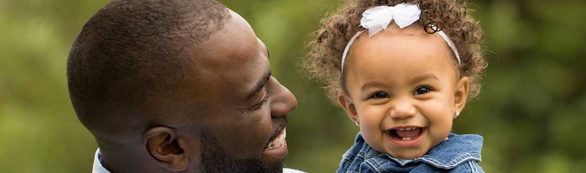 A father holding his daughter