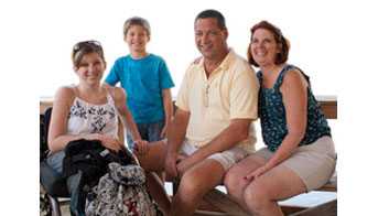 A family sitting on a bench