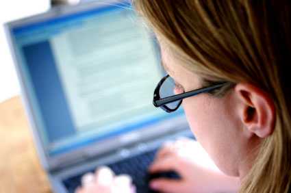 Looking over the shoulder of a woman working on her laptop