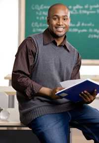 Teacher sitting on desk