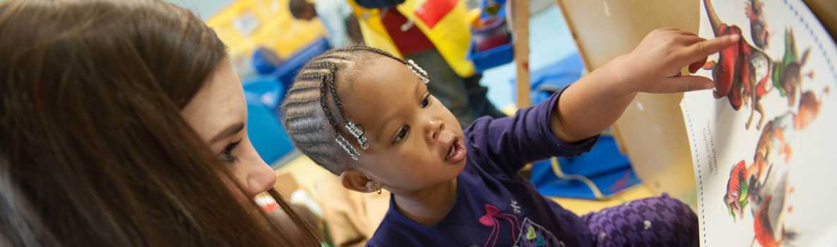 A child pointing to show his caregiver something interesting