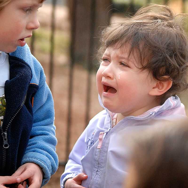 A girl cries on the playground.