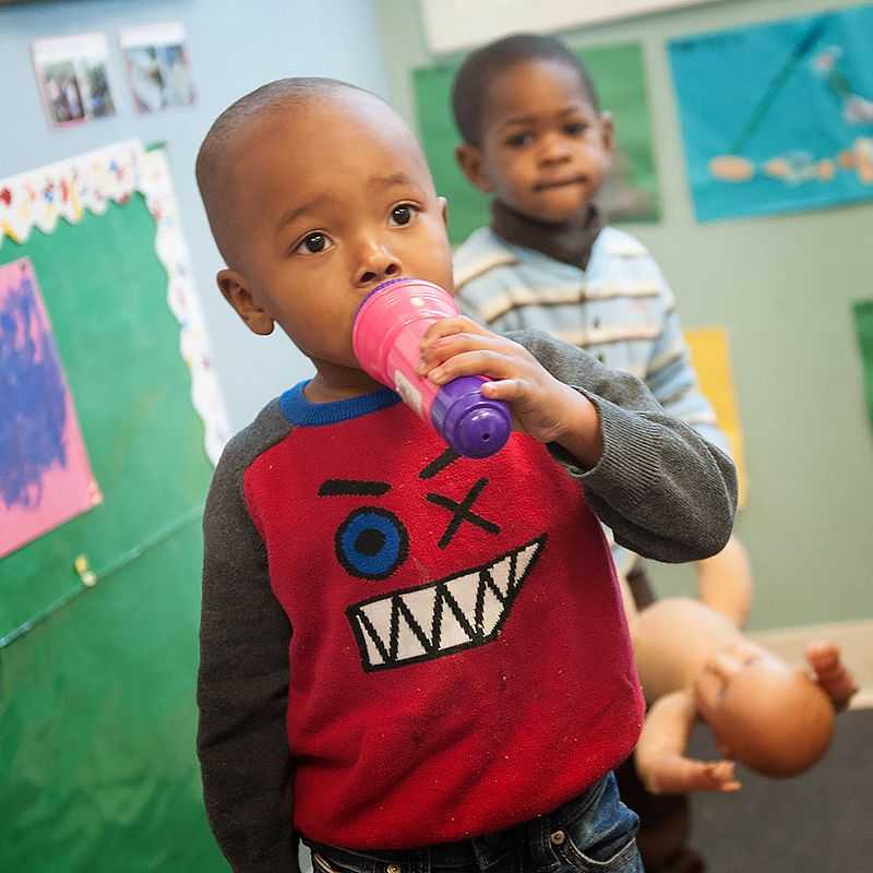 A boy sings into a microphone.