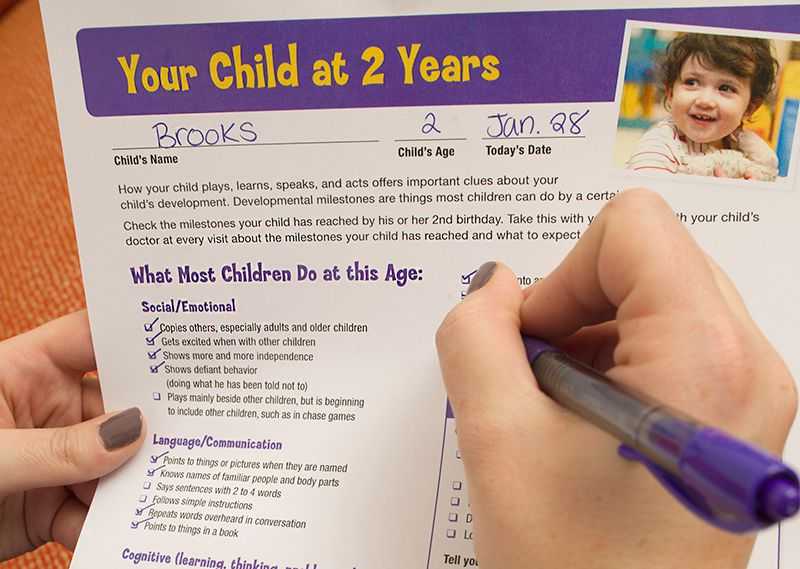 A childcare provider checks items off the Milestone Moments checklist.