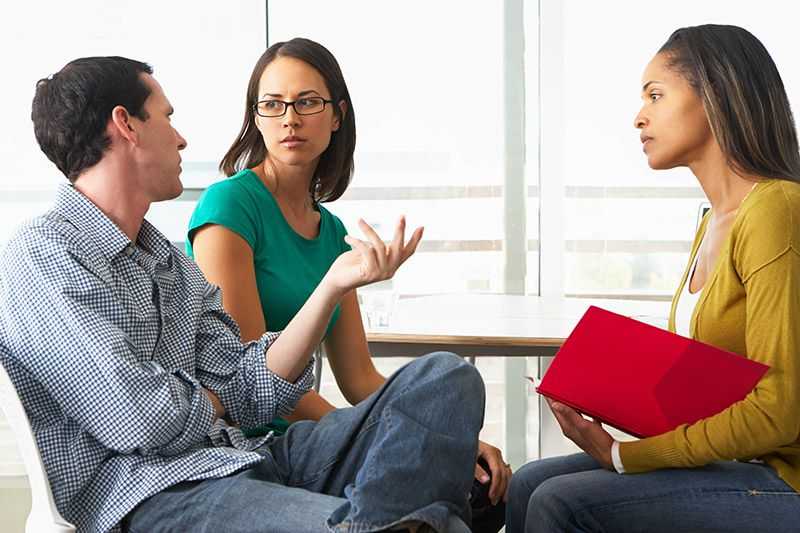 A childcare providor talks to parents.