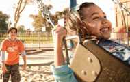 Children swinging at the park