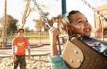 Photo of child and mother playing at a playground