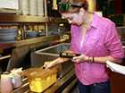 Photo of a food worker taking the temperature of some food