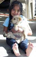 A girl holding her puppy.