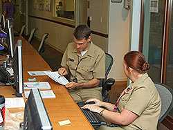 	Kevin Chatham-Stephens, MD, MPH (EIS 13) and Ethel Taylor, DVM, MPH (EIS 09 ) review the results of one of 574 telephone questionnaires conducted by CDC staff and Emory volunteers in CDCs Emergency Operations Center during an investigation of illness associated with dietary supplements.