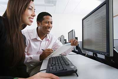 a%20male and female scientist looking at data on a computer