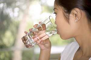 woman drinking a glass of water