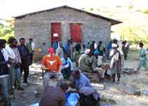 Epidemiologist Matthew Murphy organizes the team for fieldwork outside a health station.