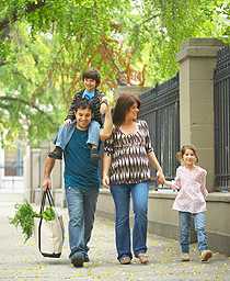 Family of four walking down the street.