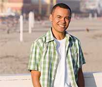 young man on the boardwalk at the beach