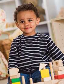 	Small child playing with building blocks