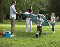 Family preparing to have a picnic in a city park