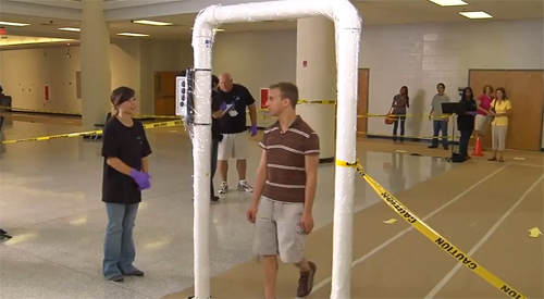 man going through portal monitor