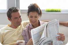 Couple reading a newspaper together