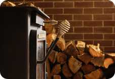 Stove with wood stacked in background