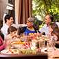 Different age groups gathered around table