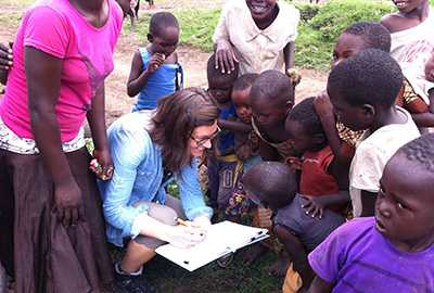 Epidemic Intelligence Service Officer Karlyn Beer greets children in a northern Tanzania village during a cholera outbreak rapid response.