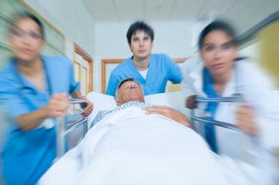 Image of doctors wearing blue garb in surgery