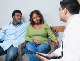 Doctor talking to 2 patients seated in chairs