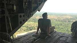 Photo: Brian Harcourt taking a breather on the edge (tethered) of a Chinook helicopter