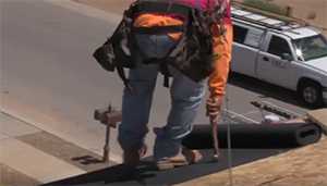 man working on a roof