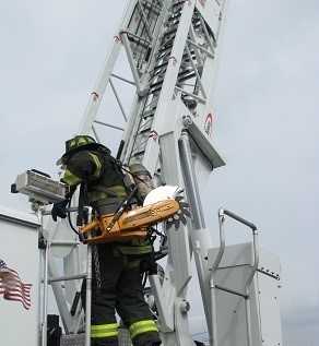 	A fire chief demonstrates the challenges in accessing an aerial ladder and truck steps.