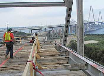 	Bridge deck construction with wooden catch platforms.