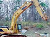 Quick-disconnect excavator bucket that detached from the excavator stick.