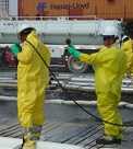 Two men in yellow safety suits monitoring the area