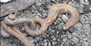 The hook and shackle attached to the track-hoe, like the one shown here (without the cable), snapped loose when the rigging failed and struck the pipelayer.