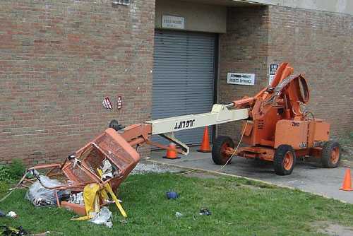 Photo 2. The aerial work platform collapsed during the incident and the lift basket crashed to the ground and landed on the grassy surface by the Field House.