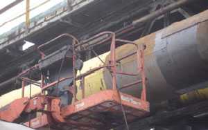 Figure 5. Gasketed steel cladding patches and man lift.