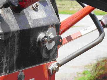 Key left in the ignition of the farm tractor that powers the feed mixer-grinder.