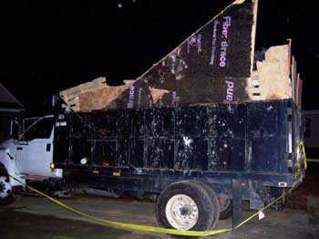 Trash truck. Scrap plywood pieces used to extend the truck bed height an additional 24 inches.