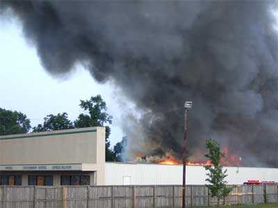 Heavy smoke pouring from the top of furniture store