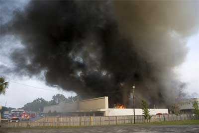 Heavy smoke pouring from the top of furniture store