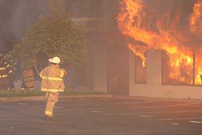 Fire pouring out of the broken windows in front of the store