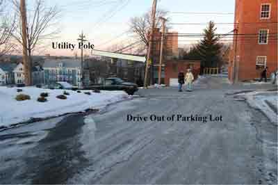 Utility pole and drive out of parking lot