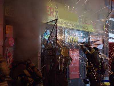 fire fighters working on store front