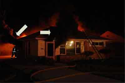 arrows pointing to fire fighter venting a window and smoking coming from a door