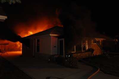 thick black smoke pushing out a vented window.