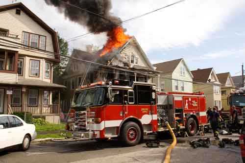 flames and dark smoke from the roof of house