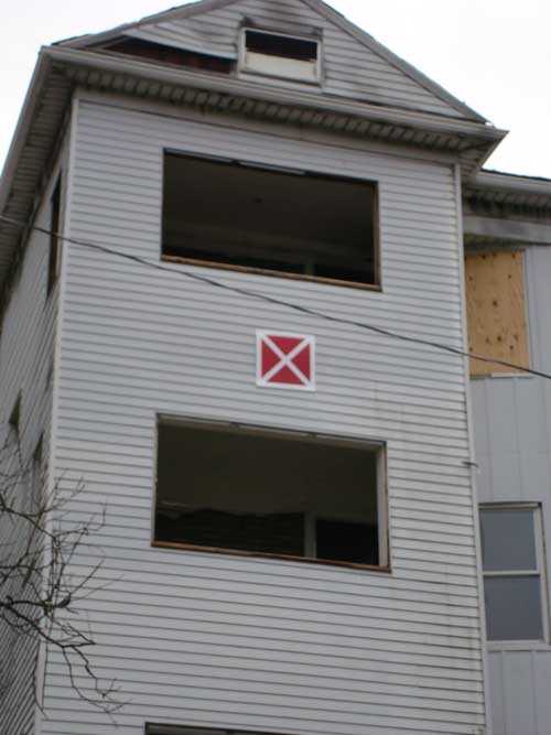 Hazardous building placard on building