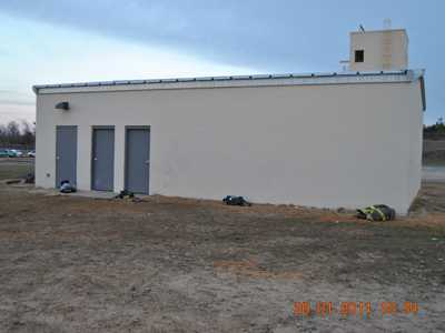 Photograph of a concrete block, 1-story smokehouse with a basement