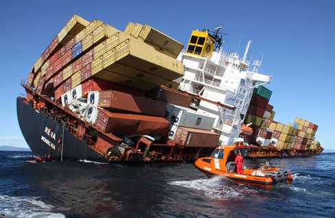 A partially capsized vessel and rescue boat.